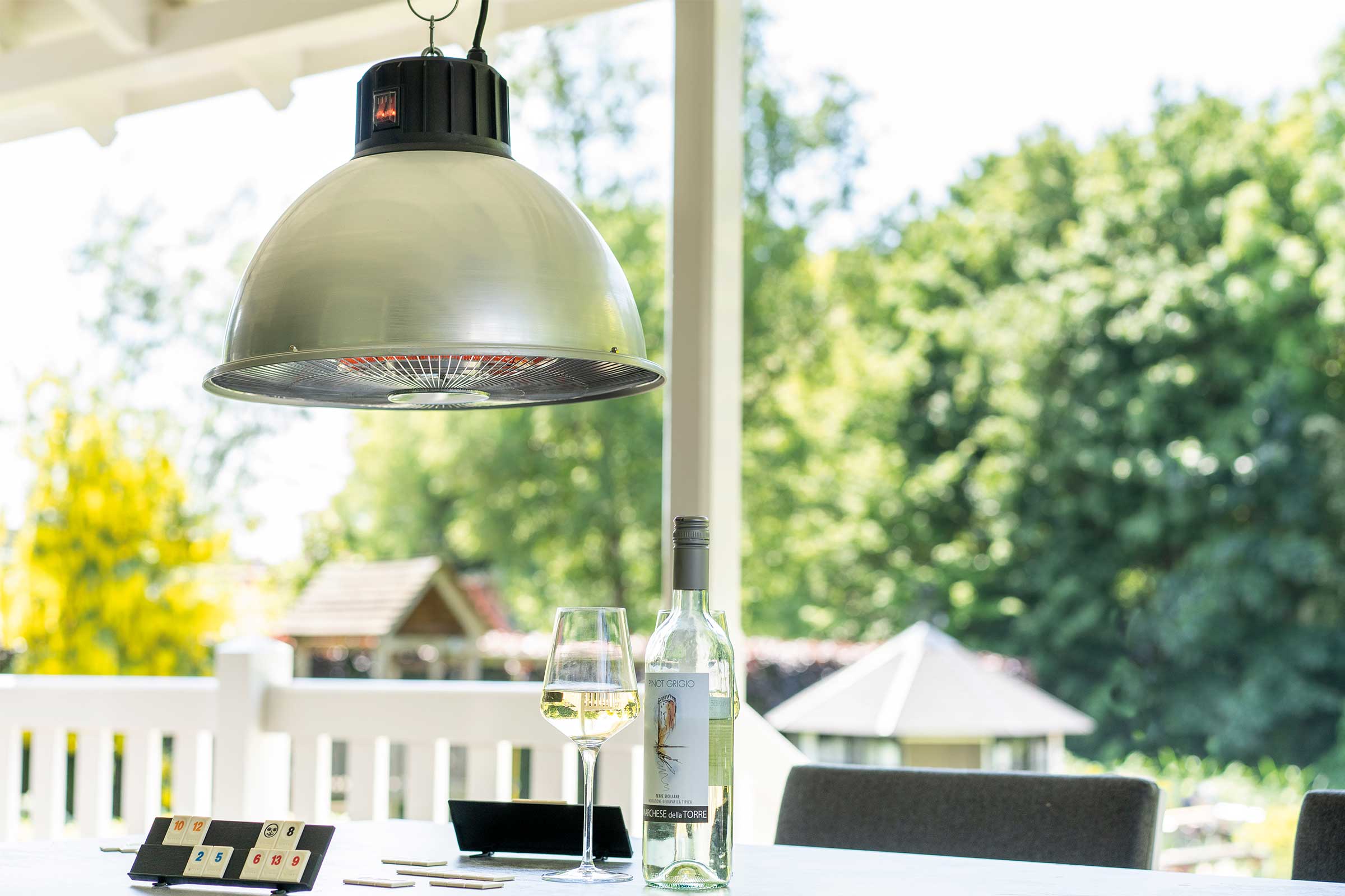 Szene mit einer Terrassenheizung, einer Flasche Wein und einem Glas auf einem Tisch
