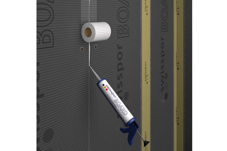 Montage d'un panneau isolant avec de la colle de montage et du tissu d'armature