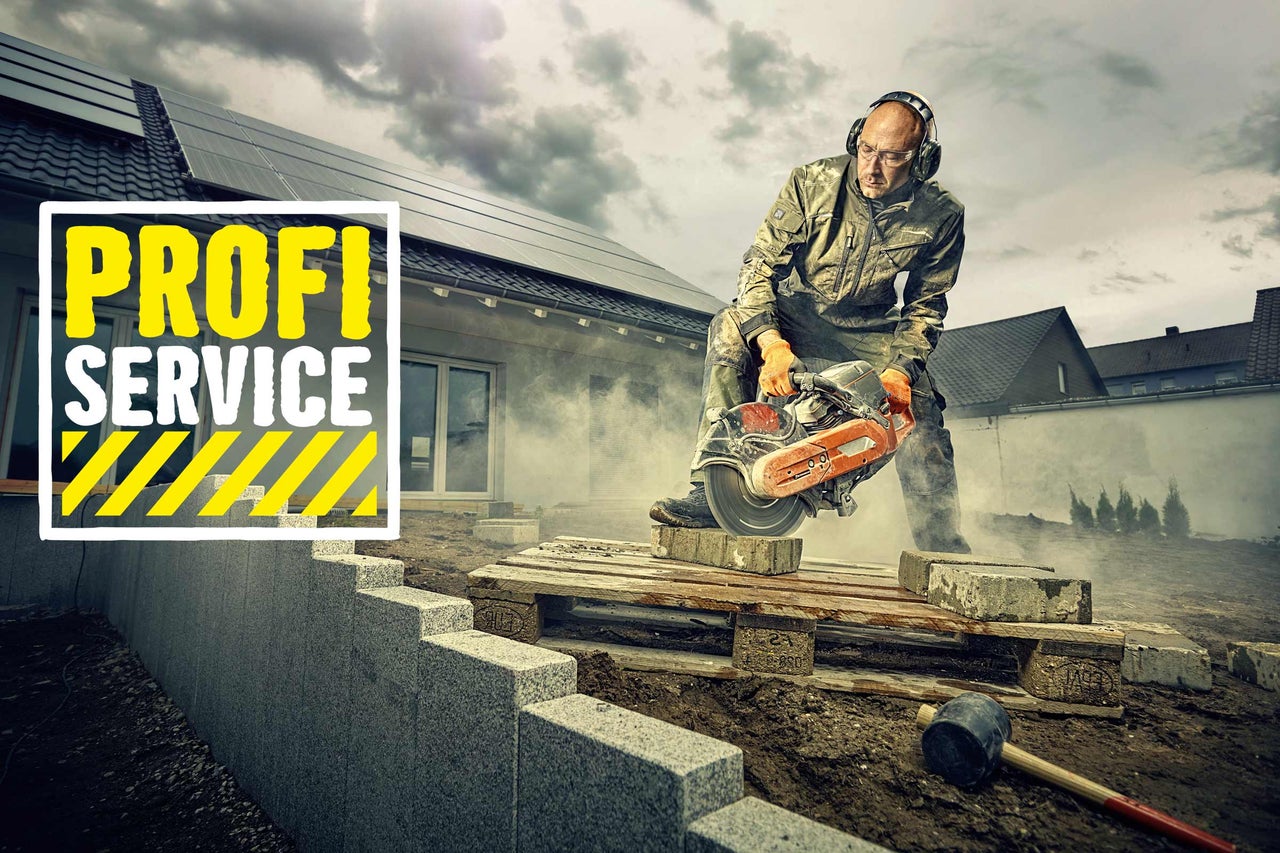 Ein Handwerker schneidet einen Stein mit einem Trennschleifer, im Hintergrund ein Haus mit Solaranlage und das Hornbach Profi Service Logo.