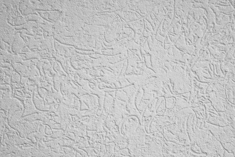 Gros plan d'un mur avec une structure d'enduit gratté