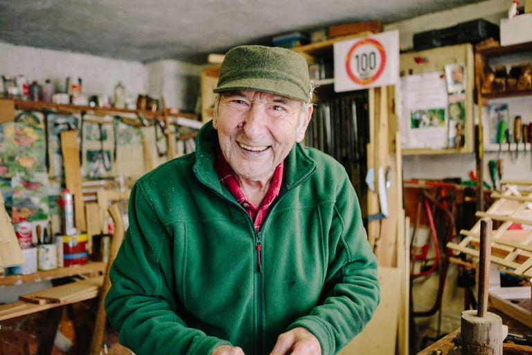 Un homme avec une casquette et une veste en polaire dans un atelier.