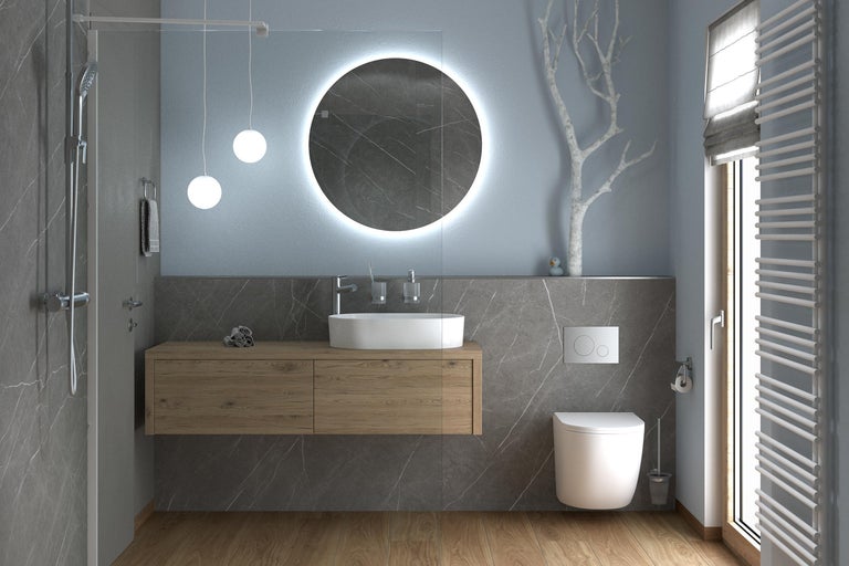 Salle de bain moderne avec meuble sous-vasque aspect bois, vasque à poser, miroir rond éclairé, toilette suspendue et douche à l'italienne.