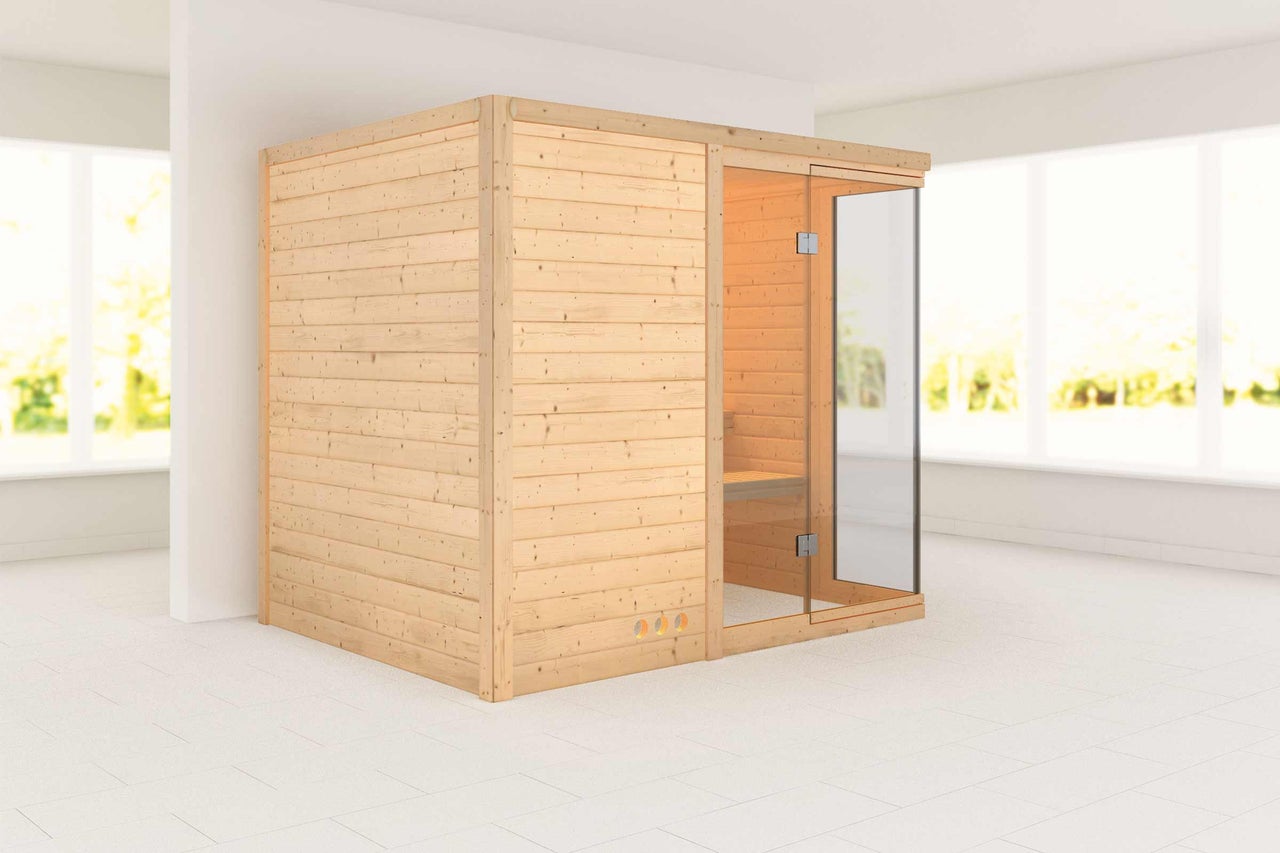 Sauna en bois avec porte en verre dans une pièce lumineuse