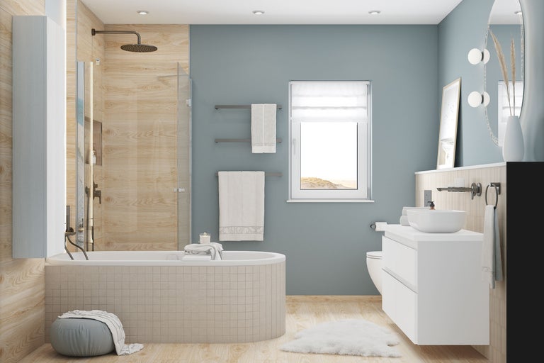 Salle de bain moderne avec baignoire, douche, meuble sous vasque blanc et carrelage mural aspect bois clair.