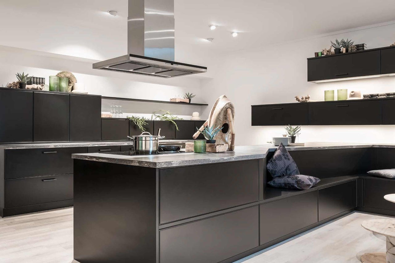 Cuisine moderne avec îlot de cuisson, banquette et hotte aspirante