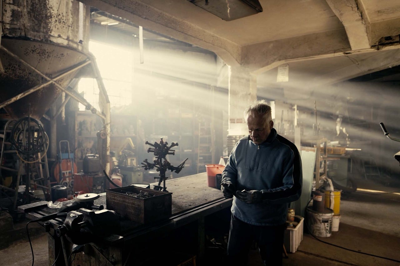 Atelier avec établi, outils et un homme au travail