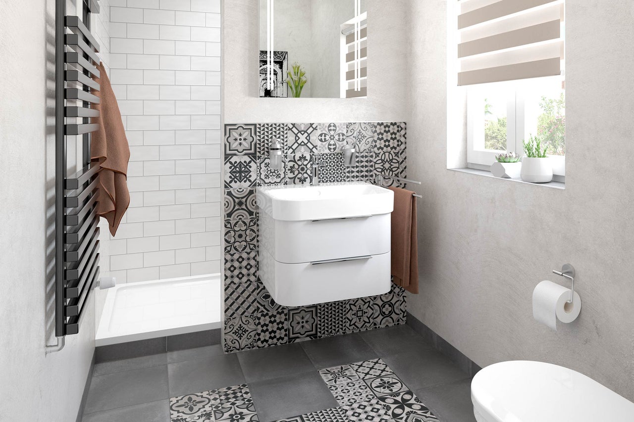 Salle de bains lumineuse avec meuble sous-vasque, radiateur sèche-serviettes et motifs de carreaux