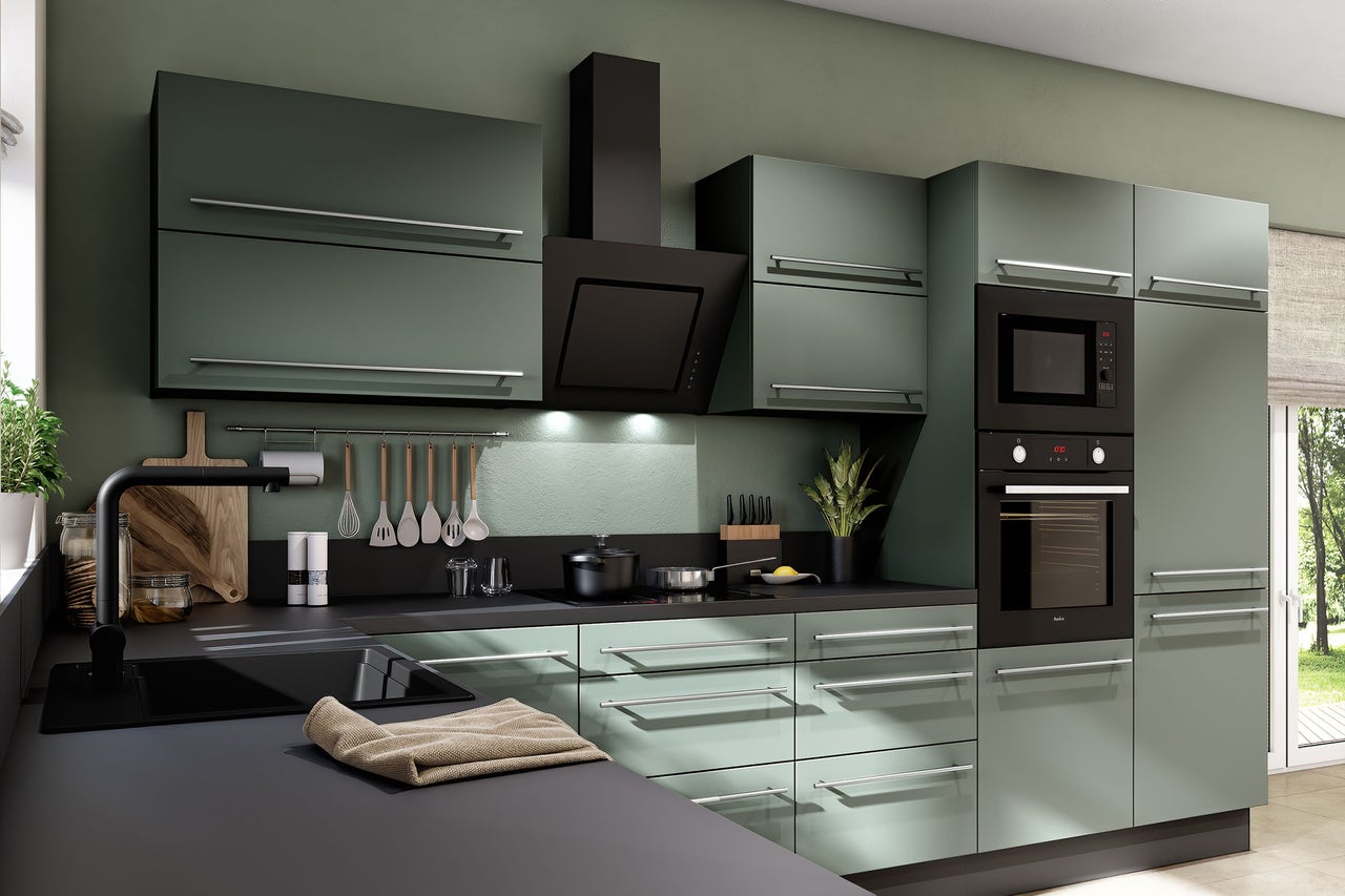 Moderne Einbauküche in Mattgrün mit schwarzer Arbeitsplatte, Backofen, Mikrowelle, Dunstabzugshaube und silbernen Griffen.