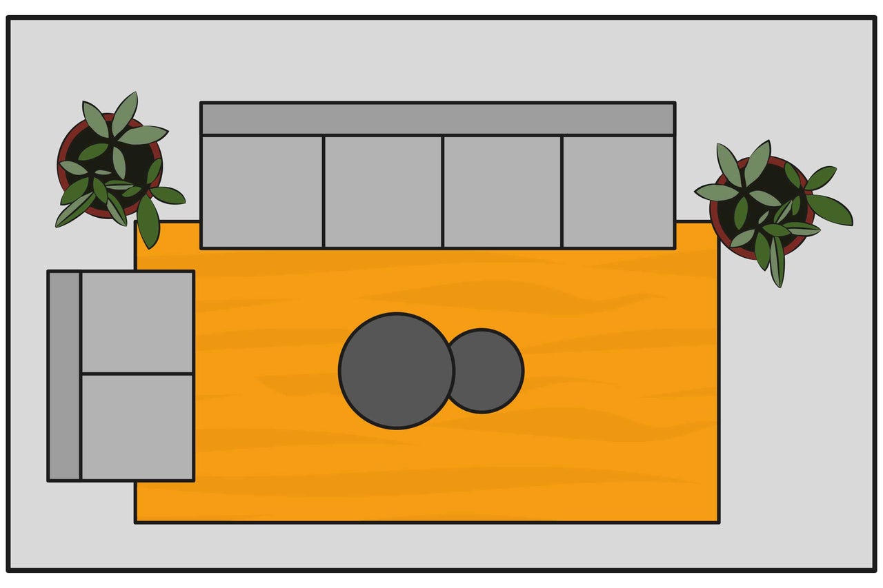 Vue de dessus d'un salon avec canapé, tapis, table basse et plantes