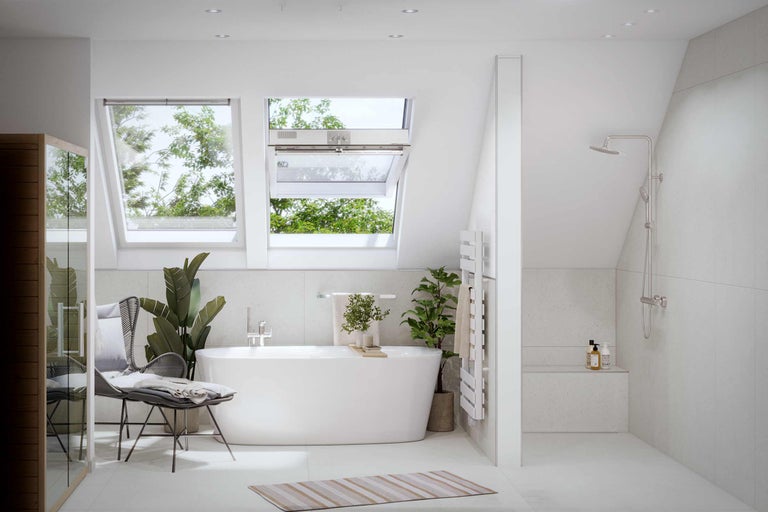 Salle de bains lumineuse avec baignoire, fenêtres de toit et douche