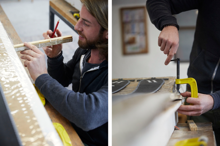 Un homme marque du bois avec un crayon. Un serre-joint à vis jaune fixe une pièce.