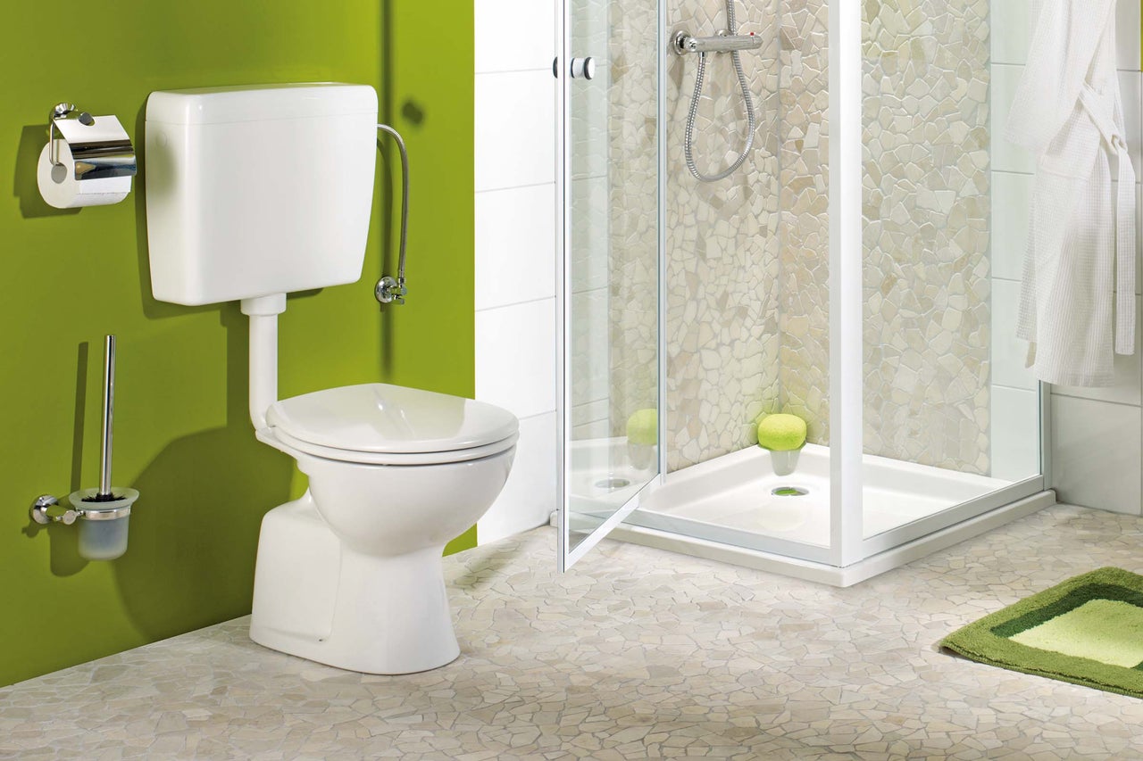 Badezimmer mit Toilette, Dusche und passenden Accessoires