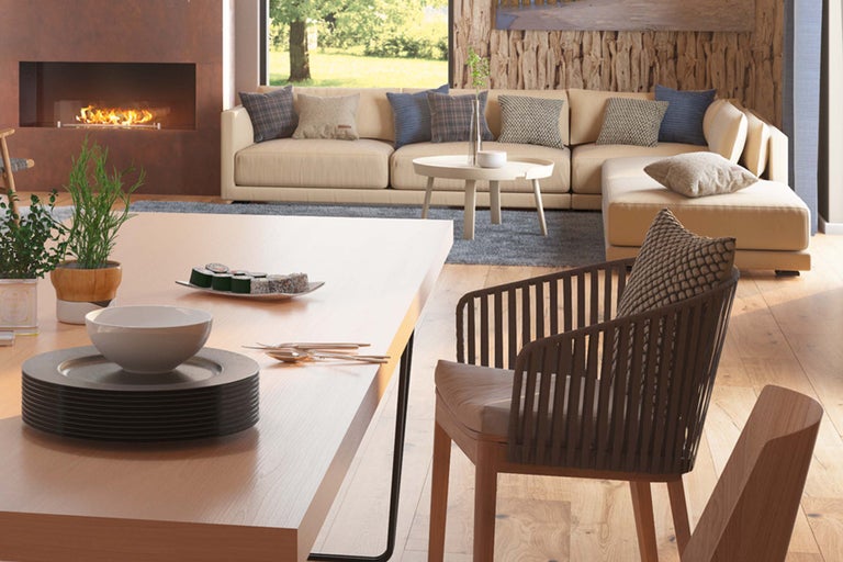 Salon lumineux avec cheminée, canapé, table et chaise