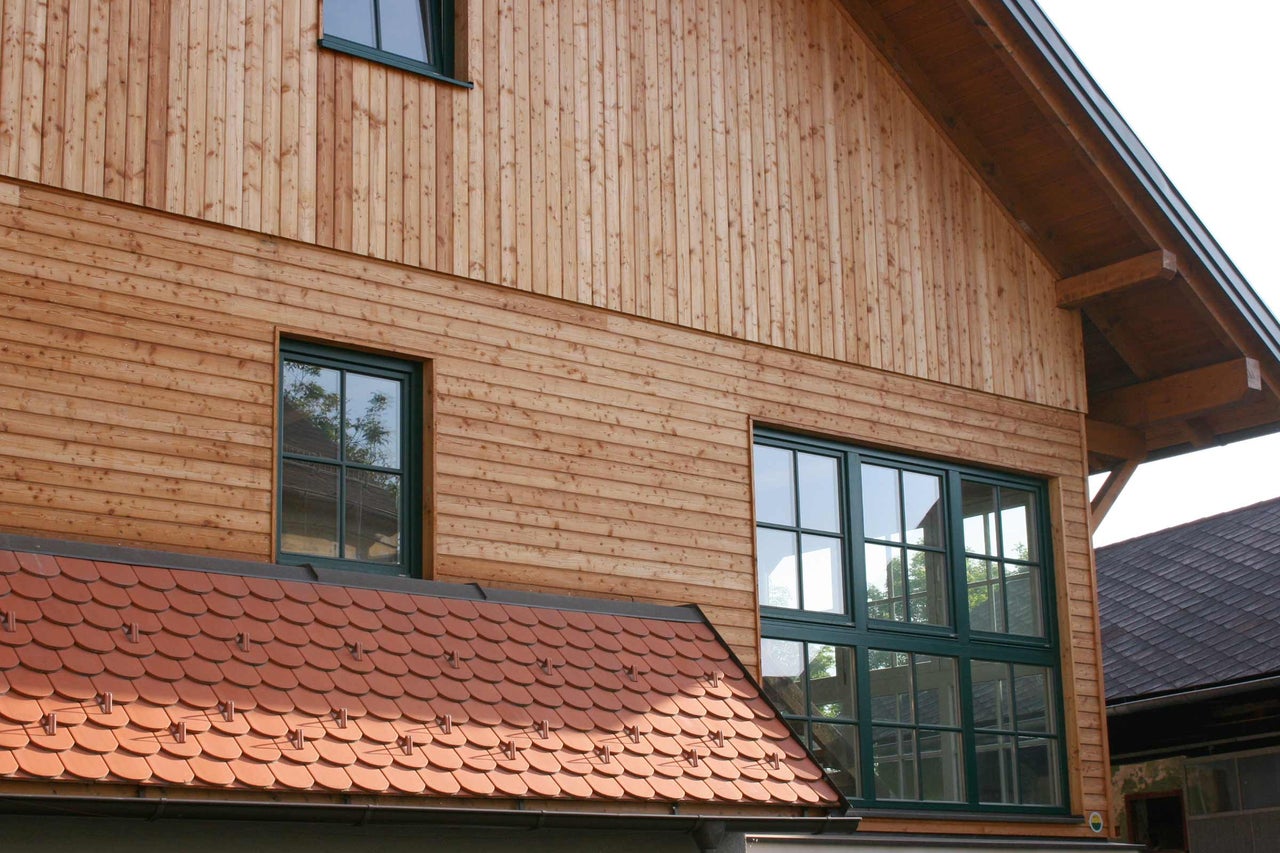 Façade d'une maison avec revêtement en bois et fenêtres