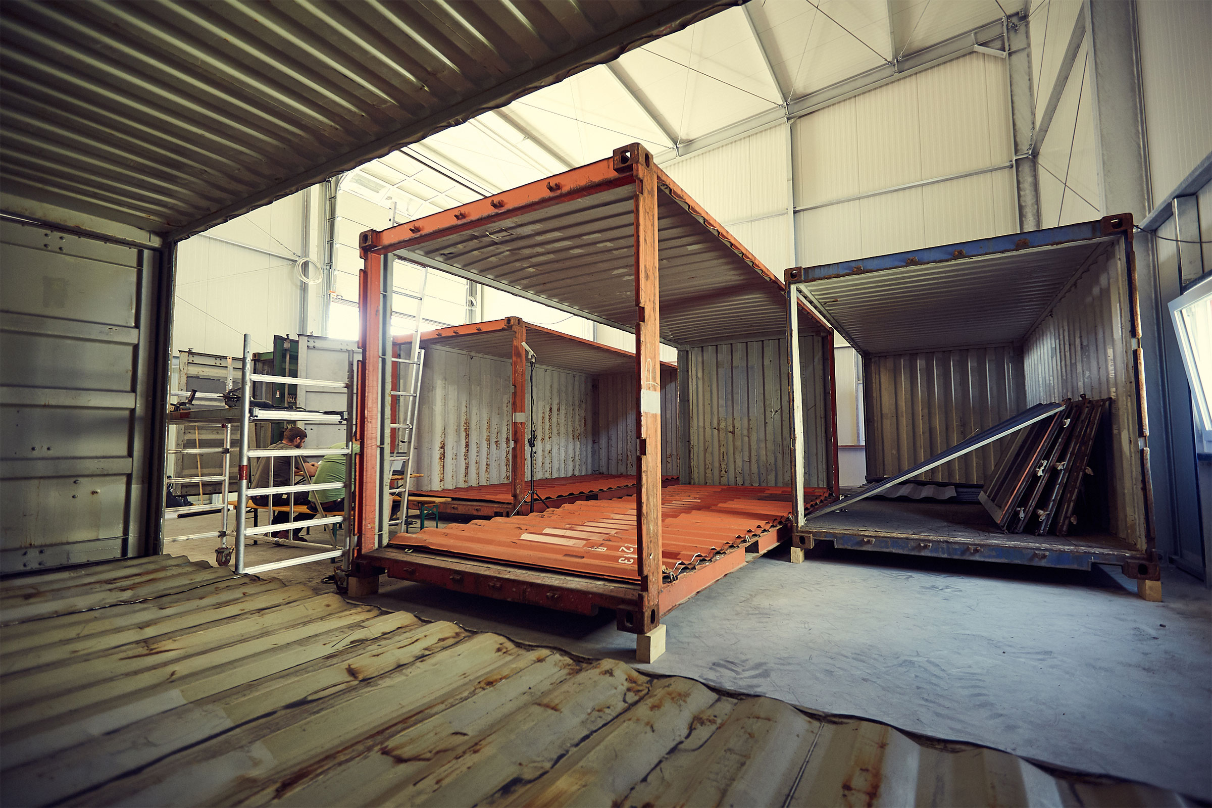 Szene mit offenen Lagercontainern in einer hellen Halle.
