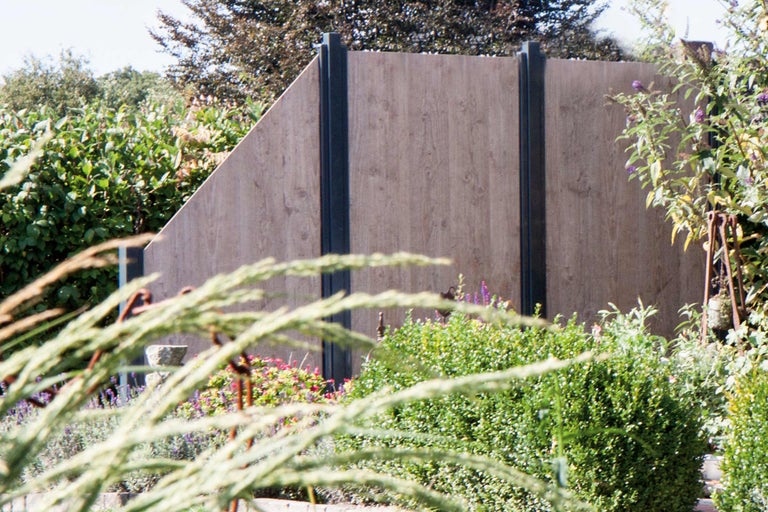 Holzzaun in einem Garten mit Pflanzen