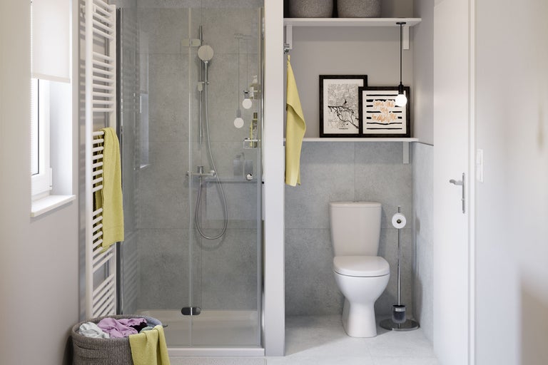 Salle de bain moderne et lumineuse avec douche en verre, murs carrelés gris, toilettes blanches et radiateur sèche-serviettes.