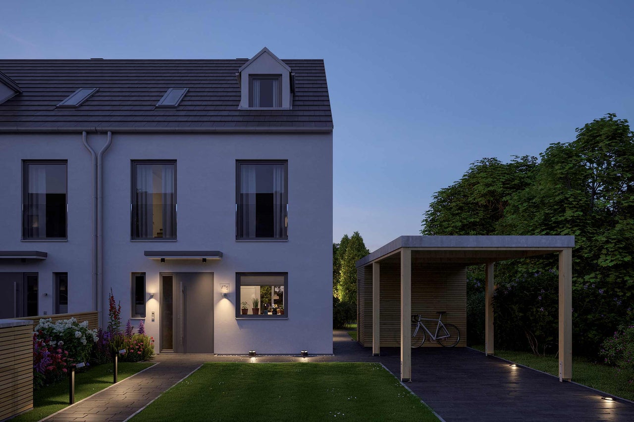 Aussenansicht eines modernen Reihenhauses mit Carport in der Dämmerung
