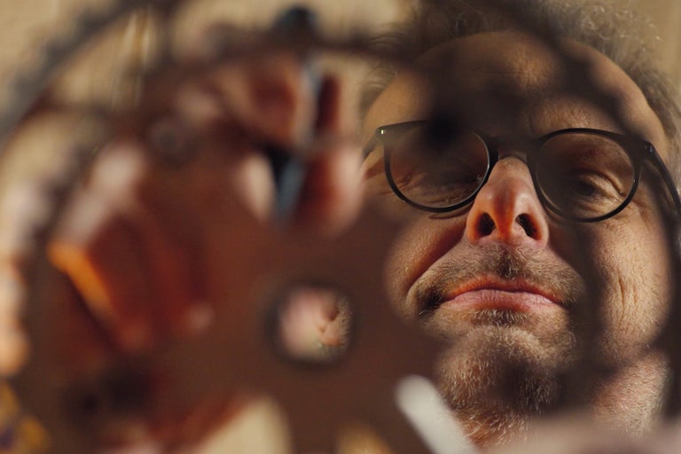 Homme avec des lunettes regardant à travers un trou