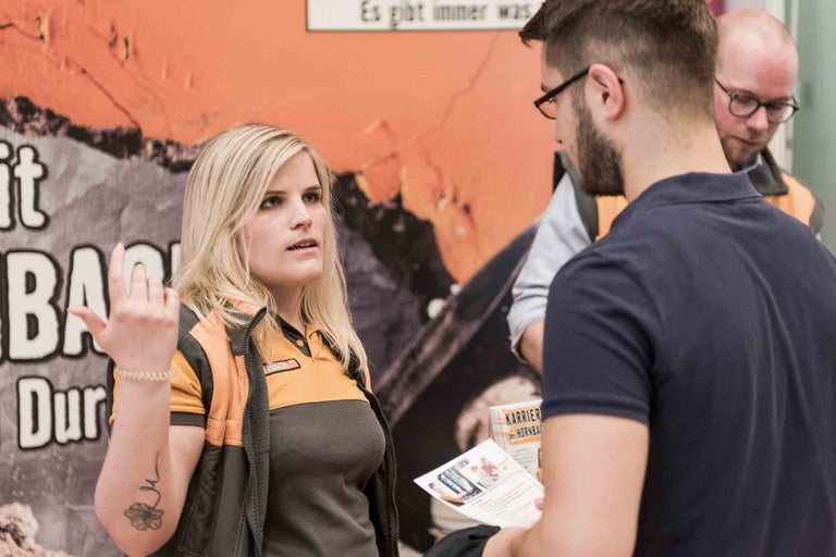 Eine Hornbach Mitarbeiterin berät Kunden über Karrieremöglichkeiten.