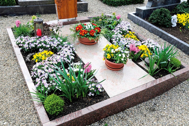 Tombe avec plantation de saison, fleurs en pots et décoration funéraire