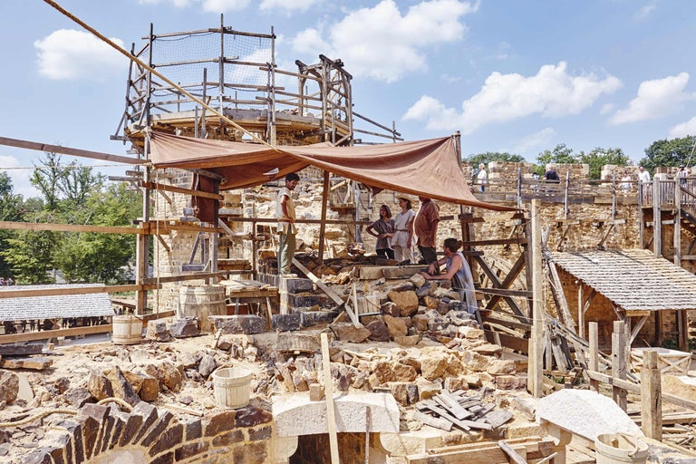 Burgbaustelle mit Holzbalken, Gerüsten und Bauarbeitern