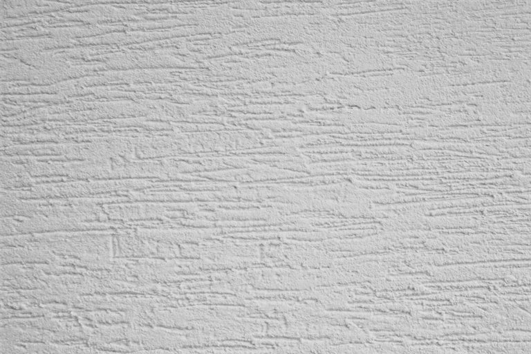 Gros plan d'un mur avec une structure en crépi gratté