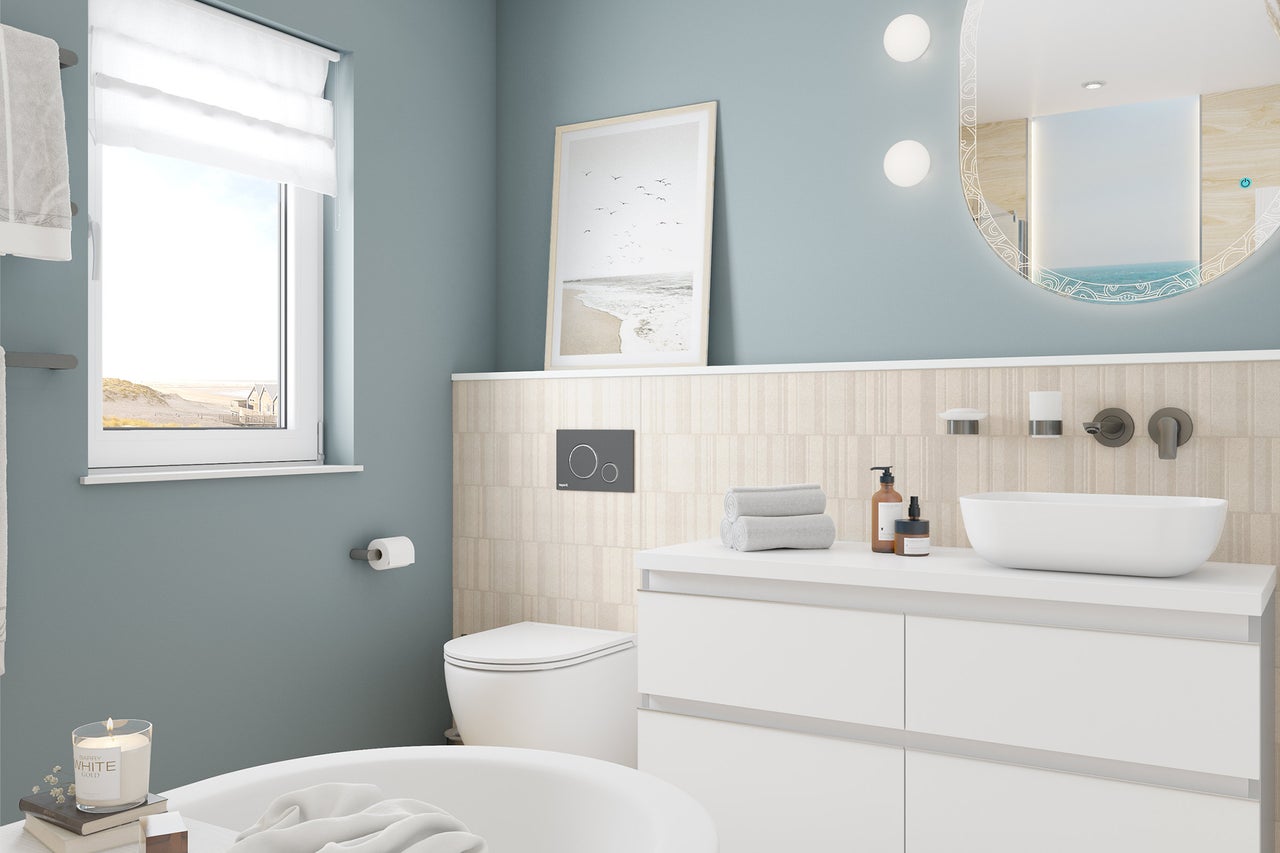 Salle de bains moderne et lumineuse avec meuble sous-vasque, vasque à poser, miroir rond éclairé, WC suspendu et fenêtre.