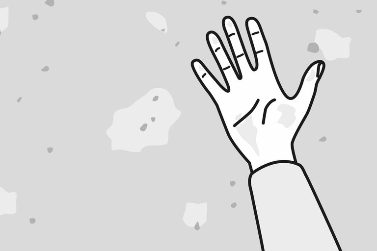 Illustration d'une main devant un mur endommagé
