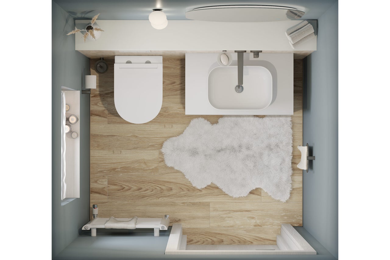 Aufsicht eines Badezimmers mit Toilette, Waschbecken, Badewanne und Badteppich