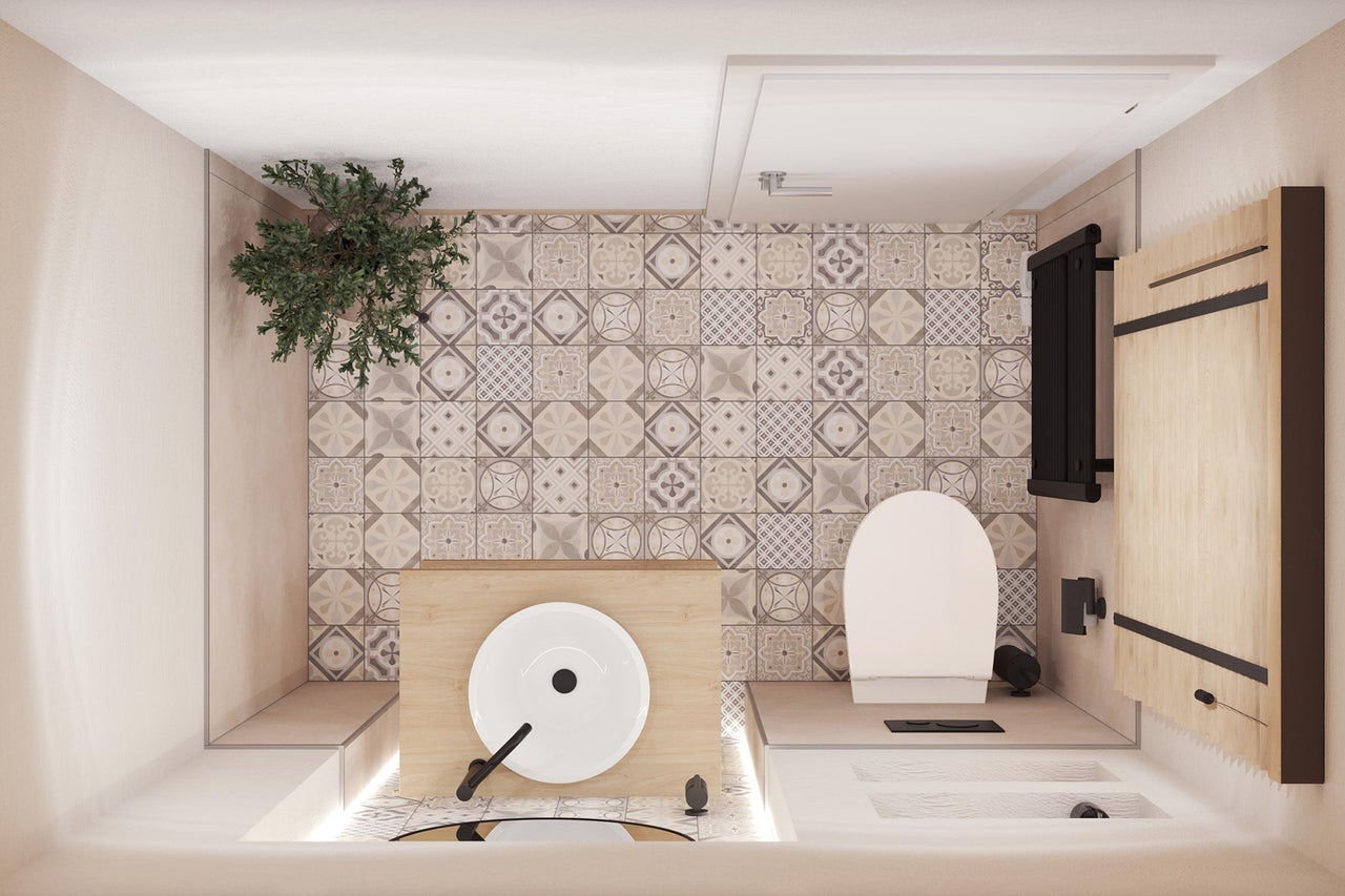 Salle de bain avec toilettes, lavabo, carrelage et radiateur