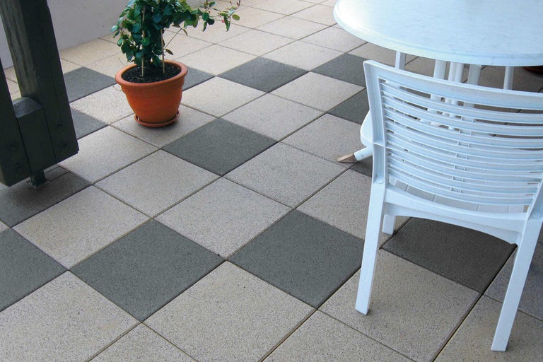 Terrasse avec dalles de terrasse en damier, table, chaise et plante en pot