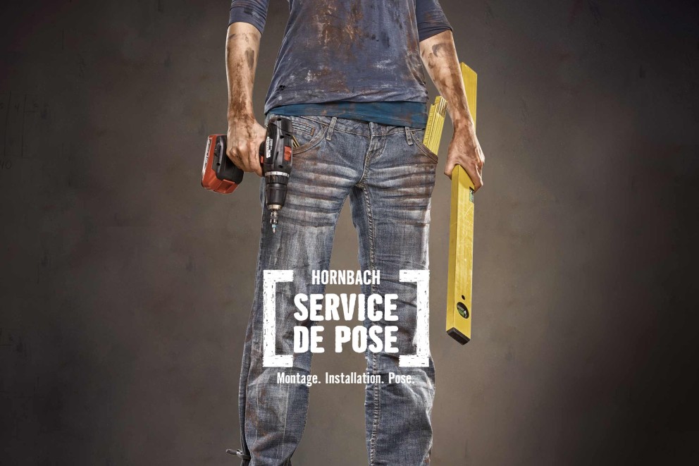 Artisan avec perceuse et niveau à bulle pour le service de pose Hornbach