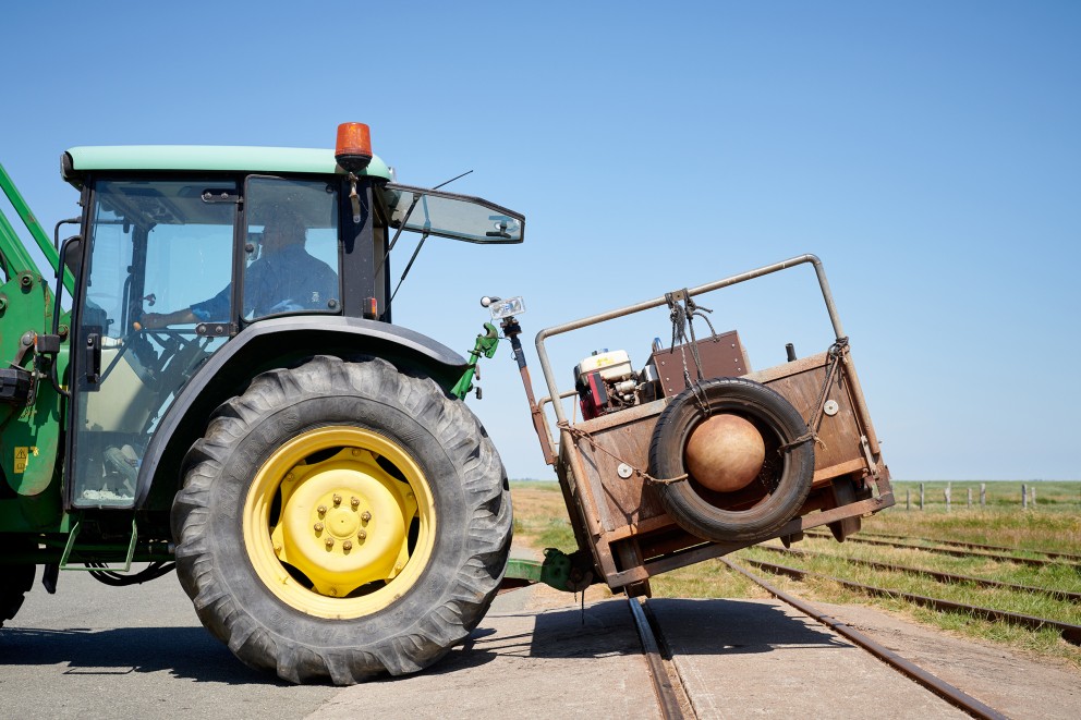 
				Avant le trajet, le wagonnet doit être hissé sur les rails à l’aide d’un tracteur.

			