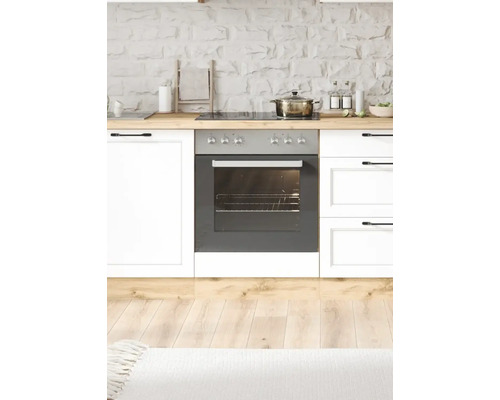 Scène de cuisine avec cuisinière, four et ustensiles de cuisine sur un plan de travail en bois devant un mur de pierre