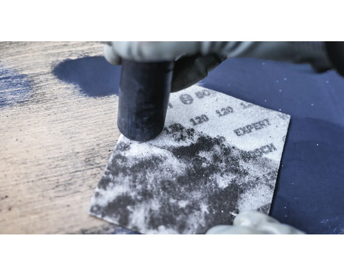 Schleifen einer Holzoberfläche mit Schleifpapier der Körnung 120 und einem Schleifklotz