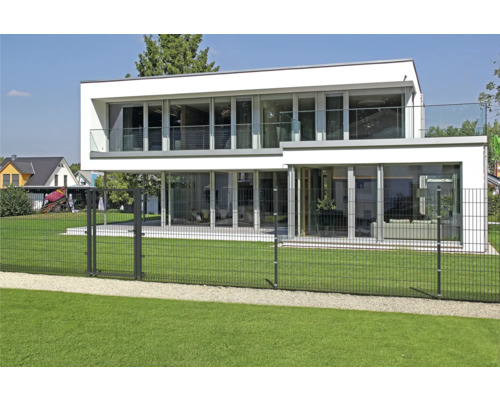 Maison moderne avec clôture en treillis soudé entourée d''une pelouse