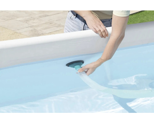 Personne connectant un nettoyeur de piscine à une piscine