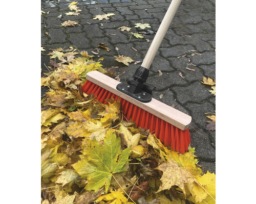 Kehrbesen mit Holzstiel und Herbstlaub