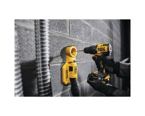 Bohrmaschine mit Staubabsaugung beim Bohren in eine Ziegelwand