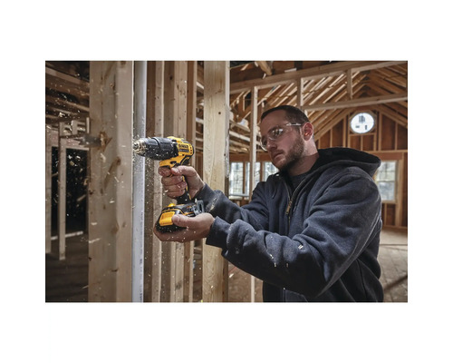 Handwerker benutzt einen Akku-Bohrschrauber von DeWalt in einem Rohbau.