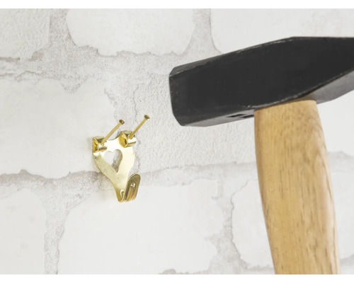 Marteau et crochet de fixation pour tableaux fixés sur un mur