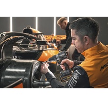 Ein Mechaniker benutzt einen DeWalt Akkuschrauber an einem Formel-1-Rennwagen.
