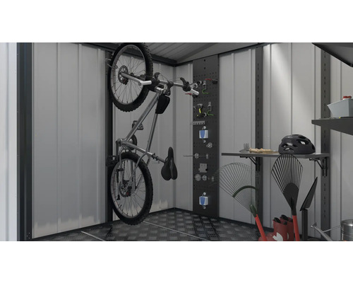 Vélo sur le support mural dans une remise avec des outils et du matériel de jardinage