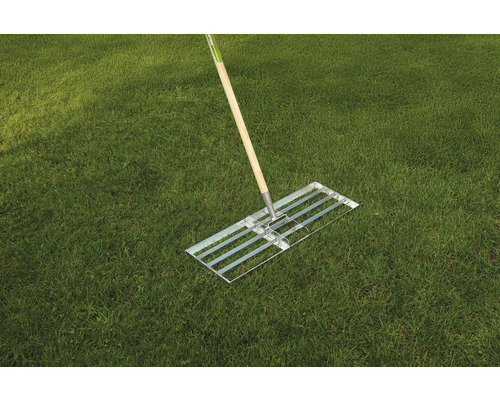 Râteau à gazon avec manche en bois sur gazon