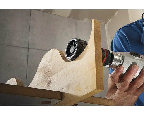 Rotationsraspel im Einsatz an einem Holzstück mit einer Bohrmaschine.