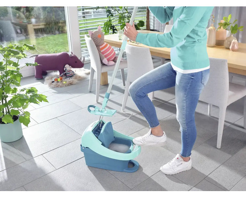 Frau benutzt einen Mopp und einen Eimer zum Reinigen des Bodens.