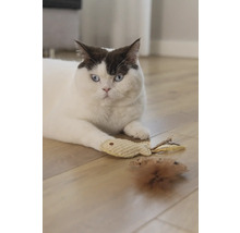 Un chat est allongé avec une souris jouet et un poisson jouet sur un plancher en bois.