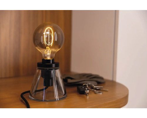 Lampe de table décorative avec ampoule apparente sur une table