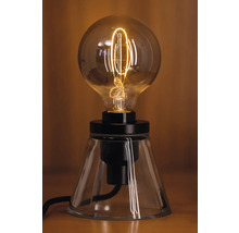 Lampe de table décorative avec une ampoule ronde sur un socle transparent.